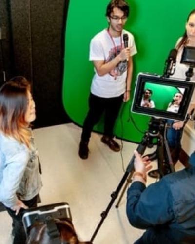 Students and a professor using a multimedia studio